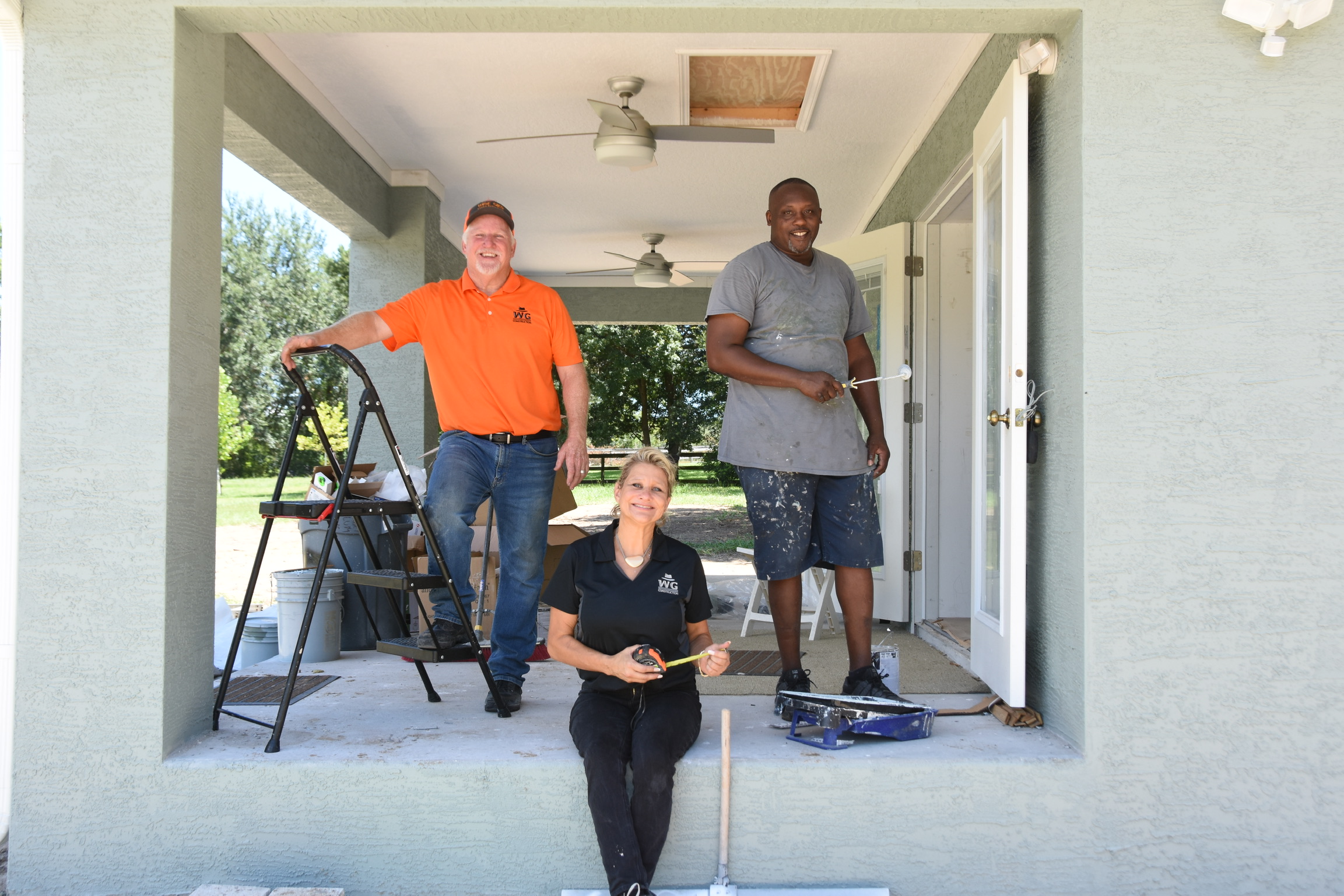The Wise Gies Construction crew on the porch of an active job site